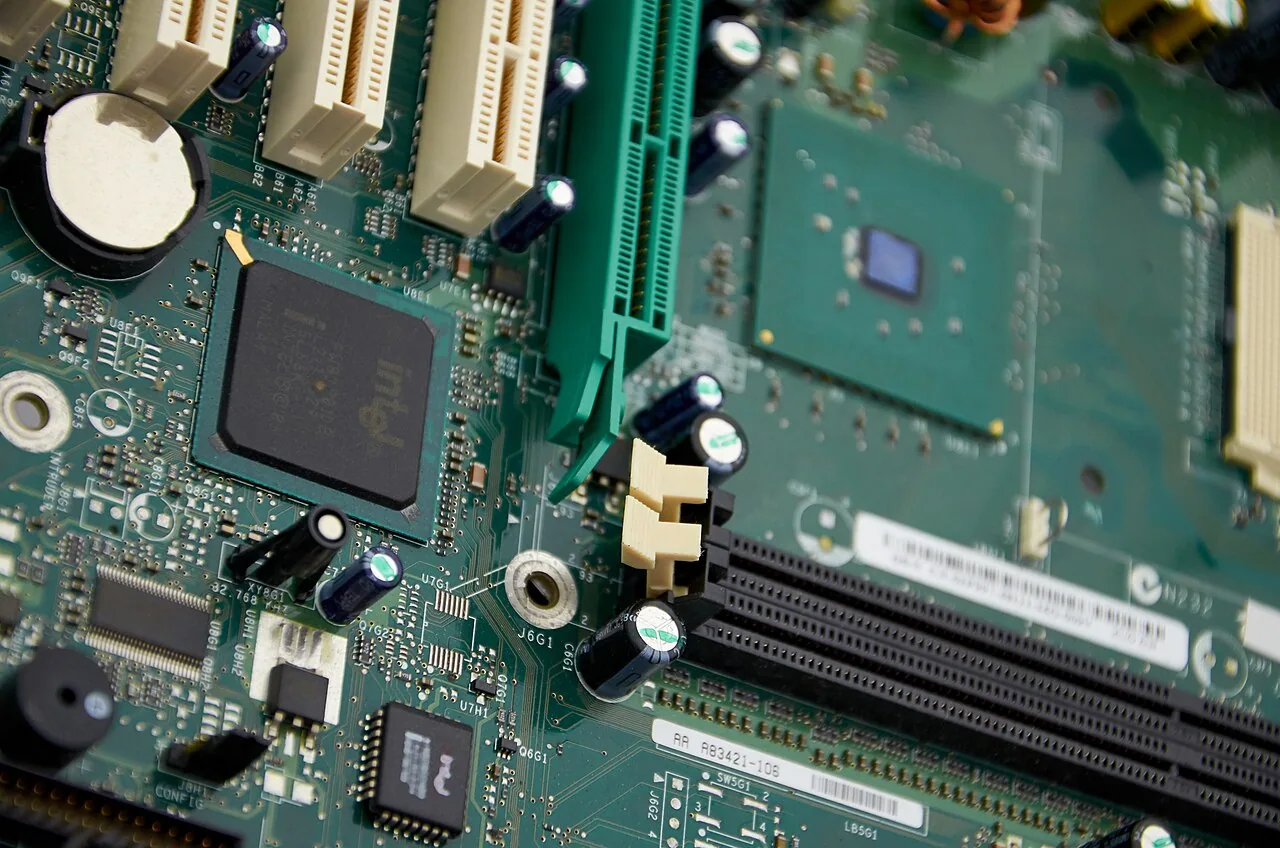 Close view of a computer motherboard, its slots, chipset and traces