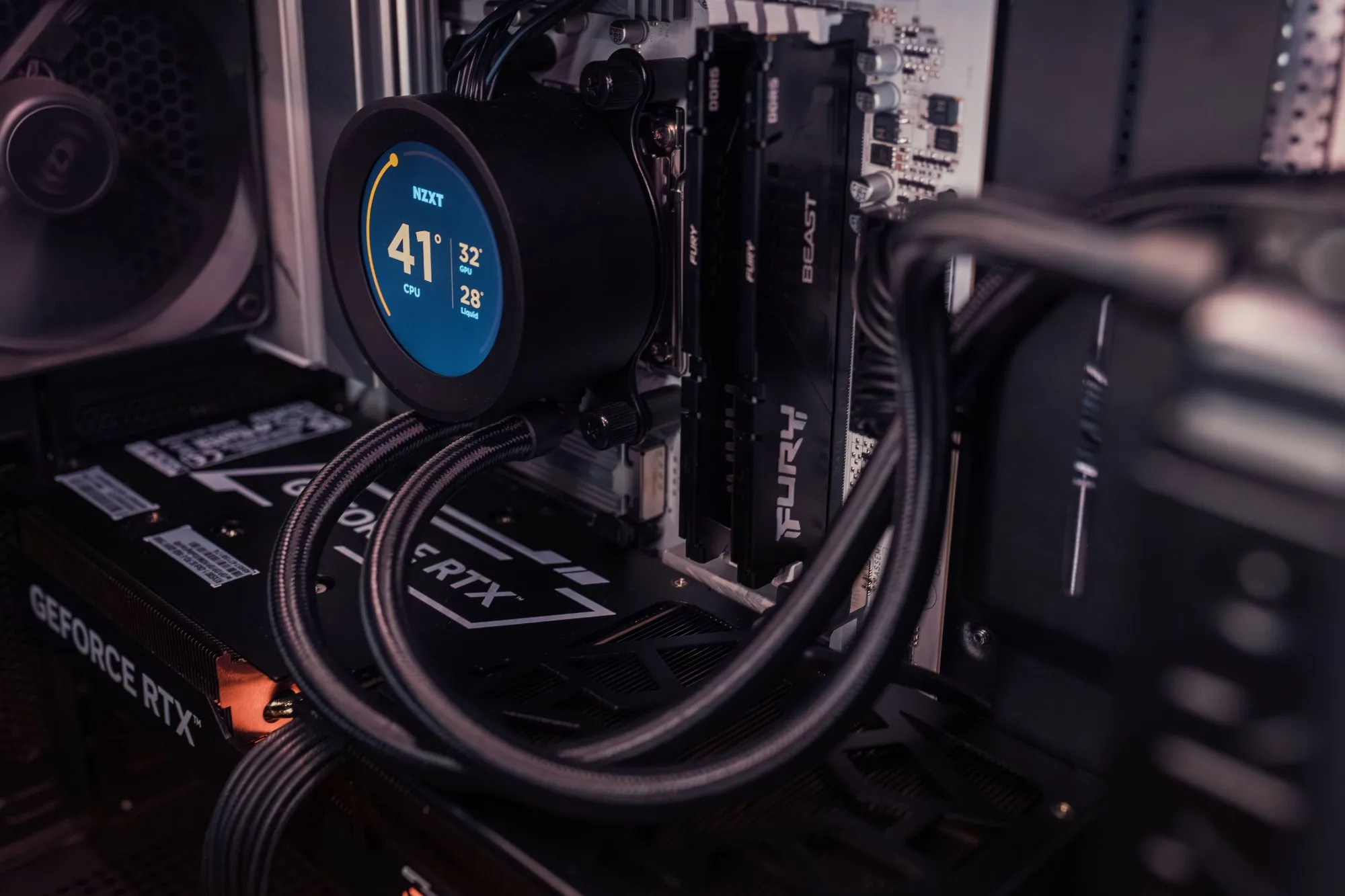 A liquid cooler display reading 41° CPU temperature inside a PC, above the graphics card and memory
