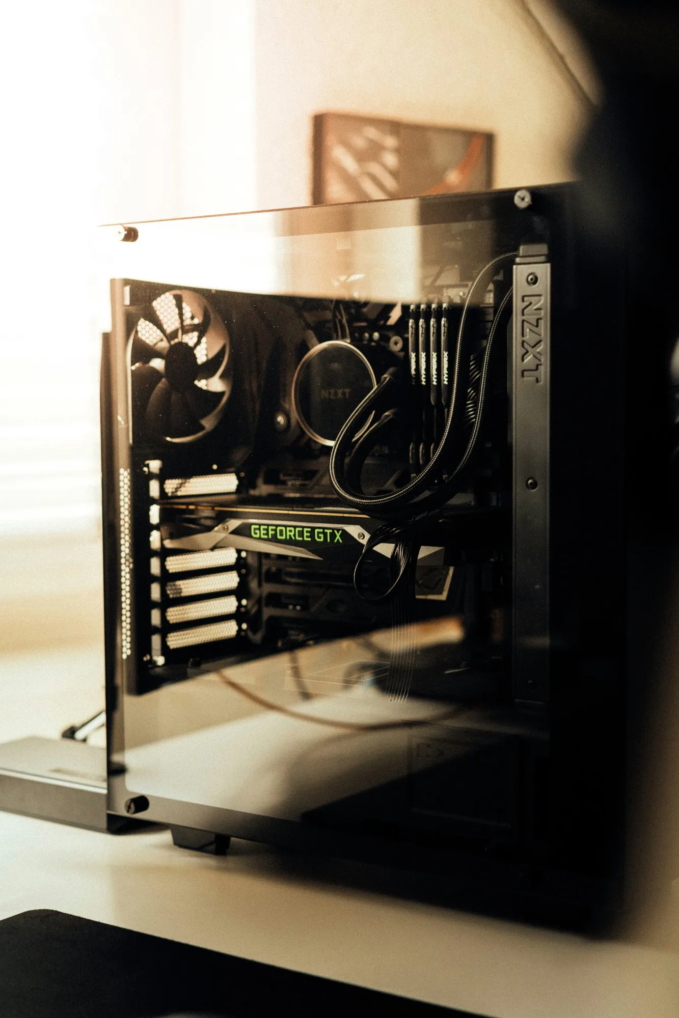 An older gaming PC with its side panel off, a GeForce GTX graphics card and air cooler inside a mid-tower case